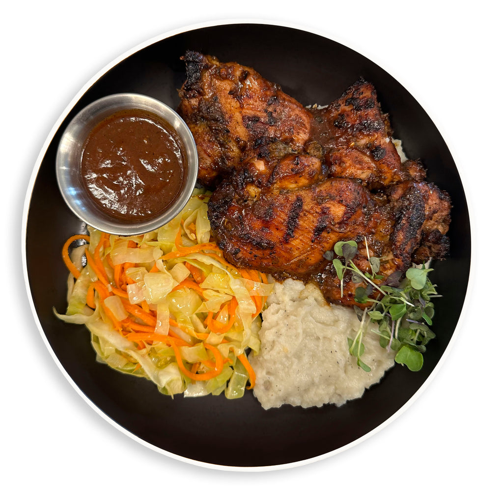 Bee Fit jerk chicken with cabbage slaw and grits